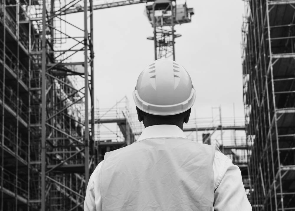 Engineer in a hard hat at a construction site